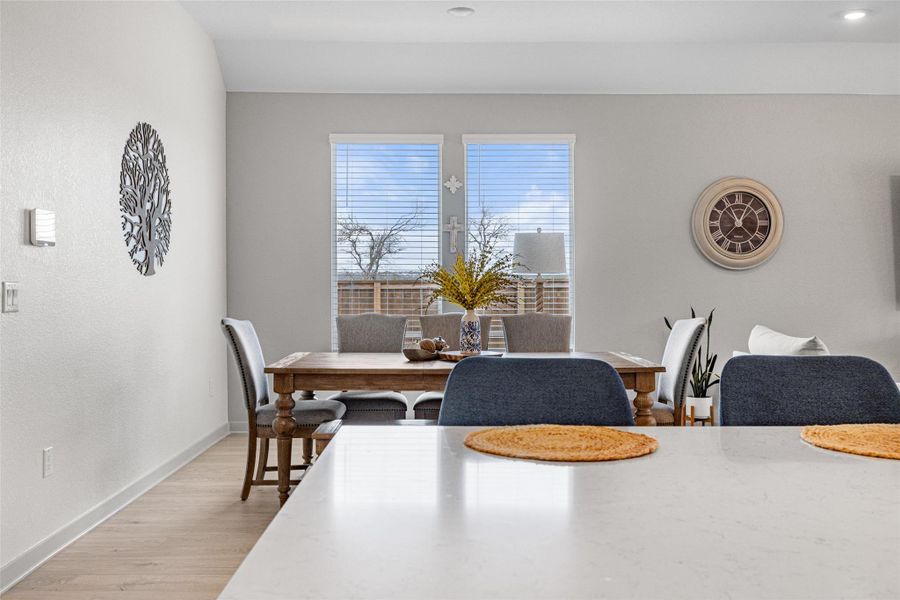 Dining space featuring baseboards and light wood-type flooring Dining space featuring baseboards and light wood-type flooring