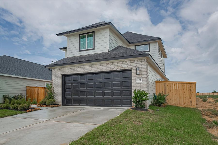 Front exterior of a new home in La Segarra, Brookshire, TX, highlighting curb appeal (Image 21).