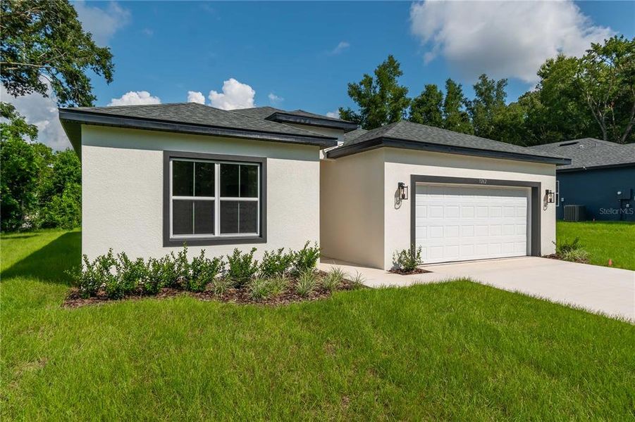 Front exterior of a new home in , Citrus Springs, FL, highlighting curb appeal (Image 20).