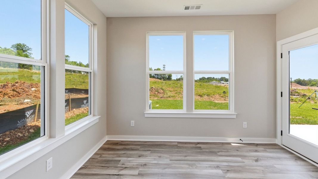 Dining area with hard surface flooring and windows