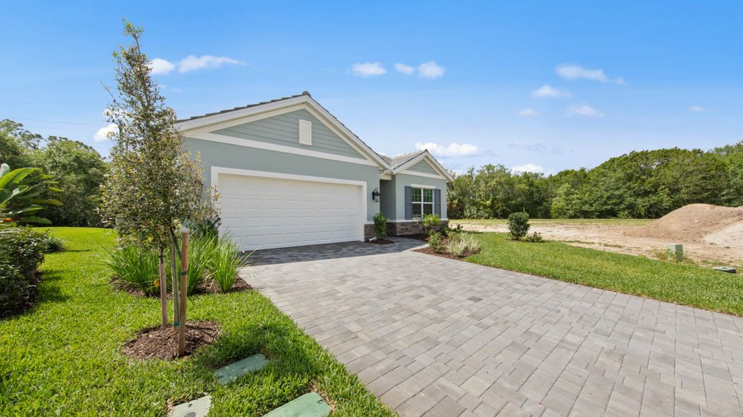 Front exterior of a new home in Verandah, Fort Myers, FL, highlighting curb appeal (Image 19).