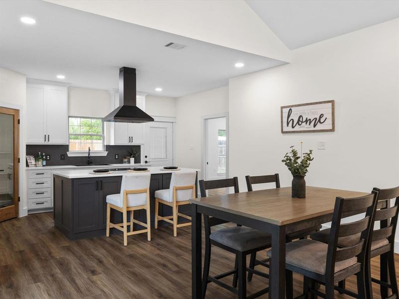 Dining area featuring dark wood-style floors and recessed lighting