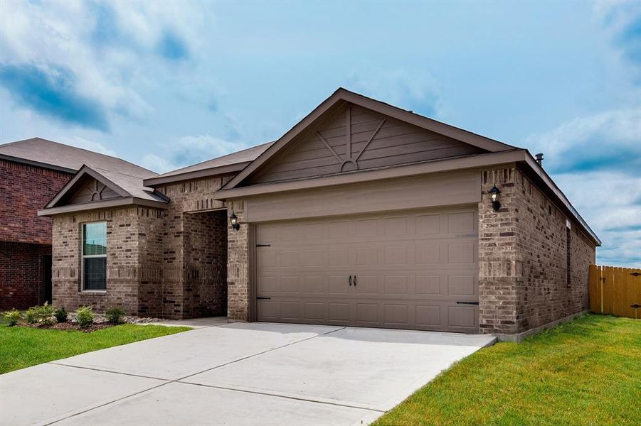 View of front of house featuring a garage and a front lawn