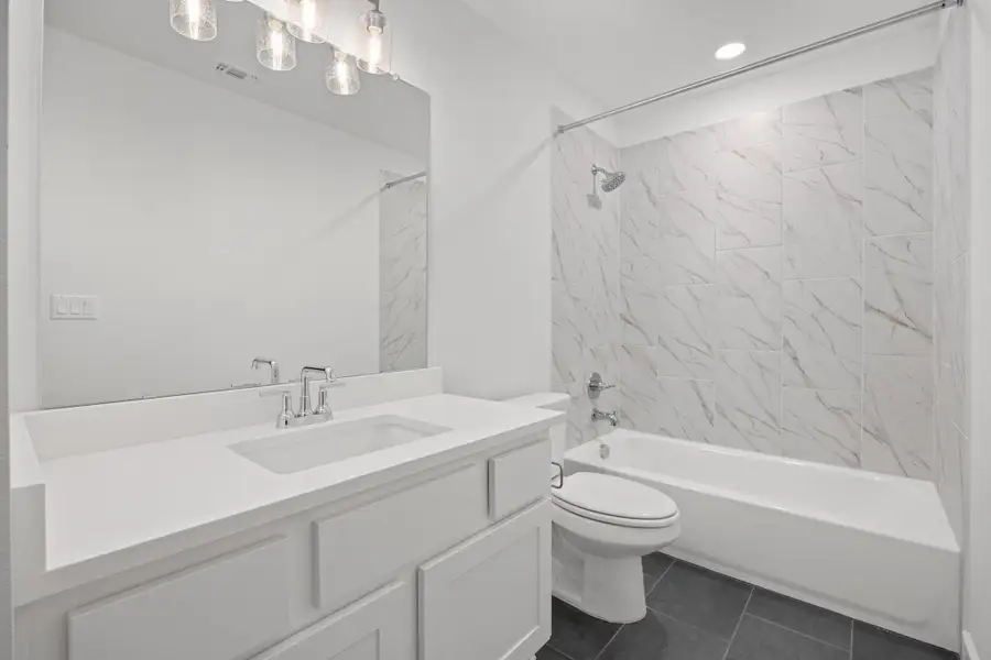 Bathroom with vanity, tub / shower combination, and tile patterned flooring Bathroom with vanity, tub / shower combination, and tile patterned flooring