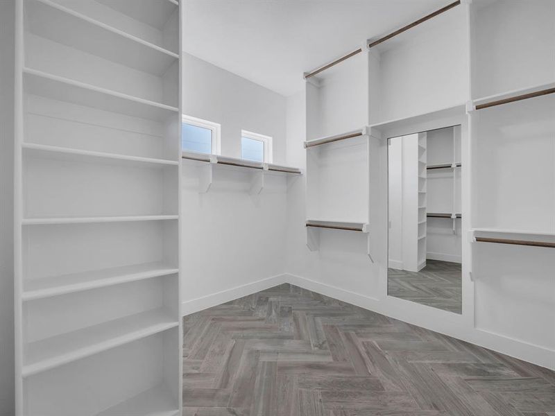 Walk in closet with parquet floors