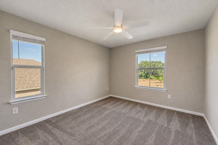 Plush carpeting and dual windows overlooking the neighborhood define this comfortable space. Plush carpeting and dual windows overlooking the neighborhood define this comfortable space.