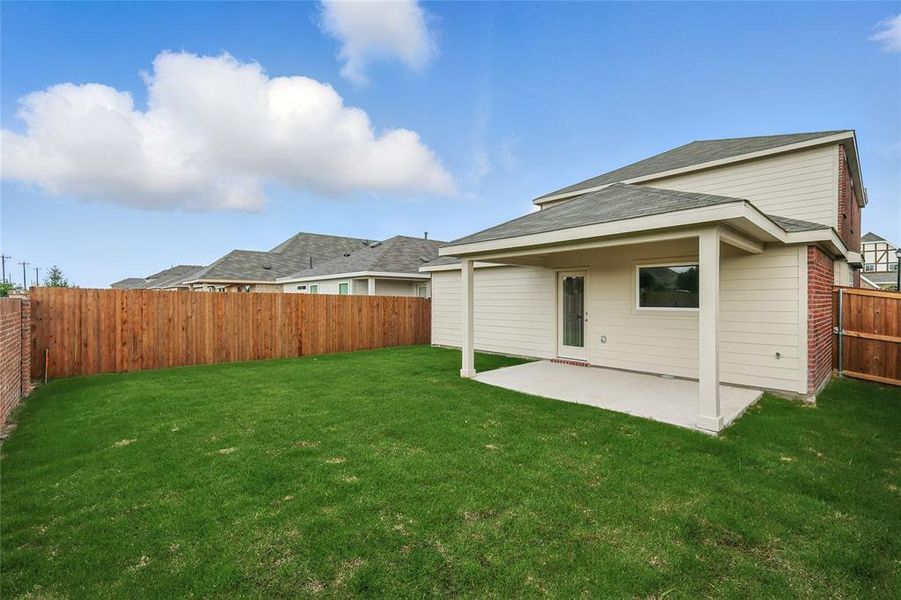 Back of property featuring a patio, a fenced backyard, and roof with shingles