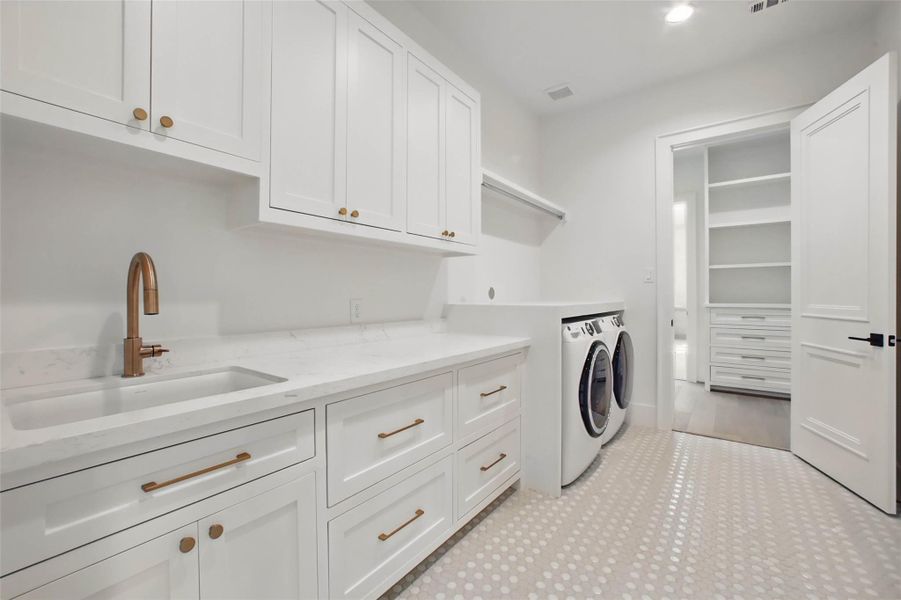 Sample of builder's previous construction. This home will have an upstairs utility room with a similar layout. Lots of storage and sink. Buyer still has time to select finishes.