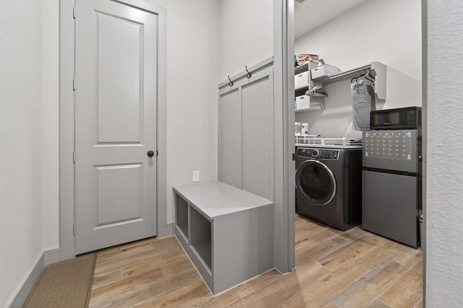 Laundry area featuring light wood-style floors and separate washer and dryer Laundry area featuring light wood-style floors and separate washer and dryer