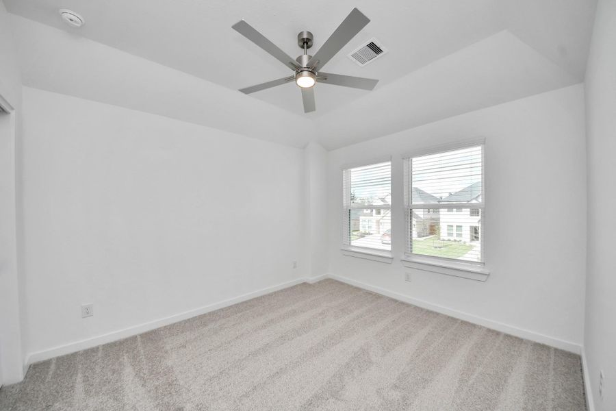 Secondary bedroom features plush carpeting, large windows that let in plenty of natural light, bright paint, and spacious closets. Secondary bedroom features plush carpeting, large windows that let in plenty of natural light, bright paint, and spacious closets.