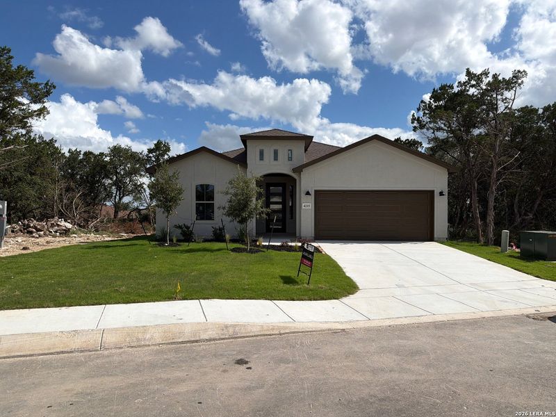 Front exterior of a new home in The Summit, San Antonio, TX, highlighting curb appeal (Image 1). Front exterior of a new home in The Summit, San Antonio, TX, highlighting curb appeal (Image 1).