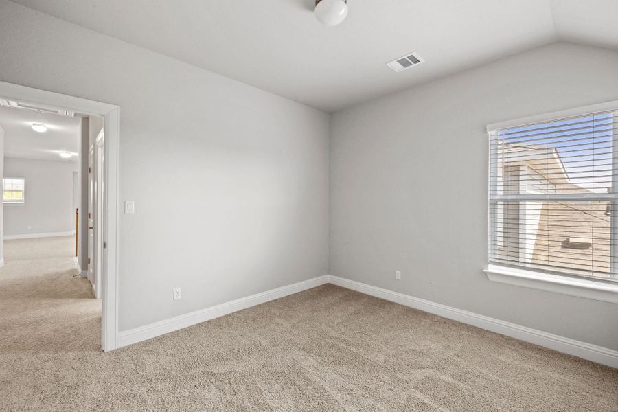 Empty room with light carpet and baseboards Empty room with light carpet and baseboards