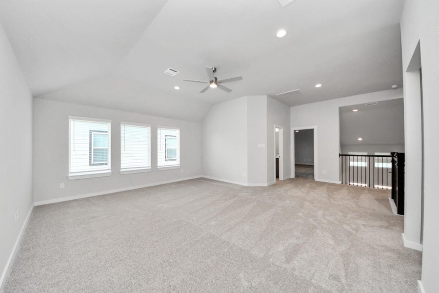 Ascend to relaxation in this fantastic game room! Ideal for both casual gatherings and adult gaming, it boasts plush carpet, lofty ceilings, custom paint, and ample windows for abundant natural light.
