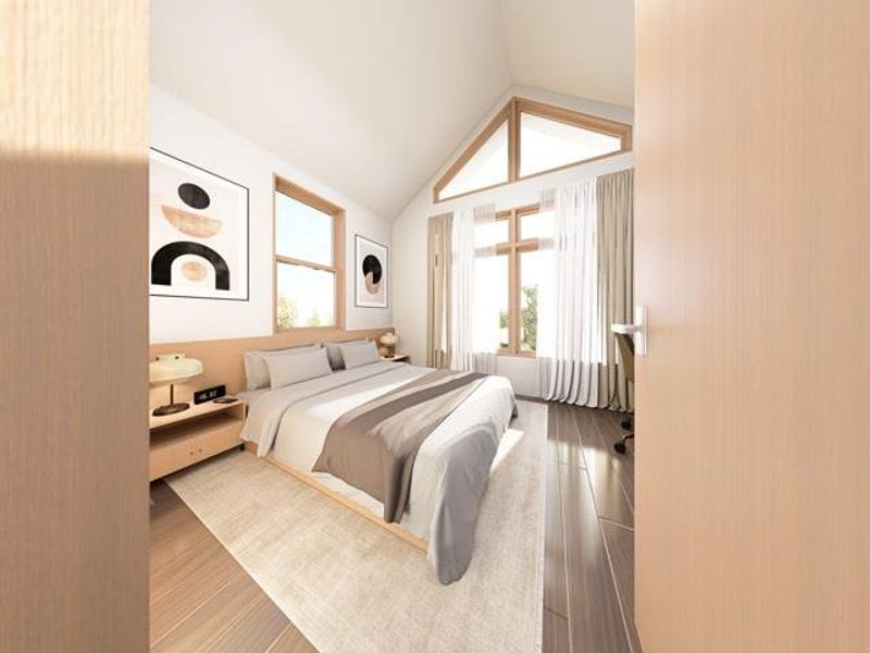 Bright and airy bedroom featuring vaulted ceilings, large windows, and modern finishes for a warm, inviting feel.