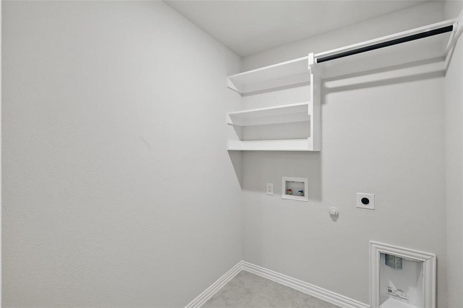 Washroom with hookup for a gas dryer, washer hookup, and hookup for an electric dryer