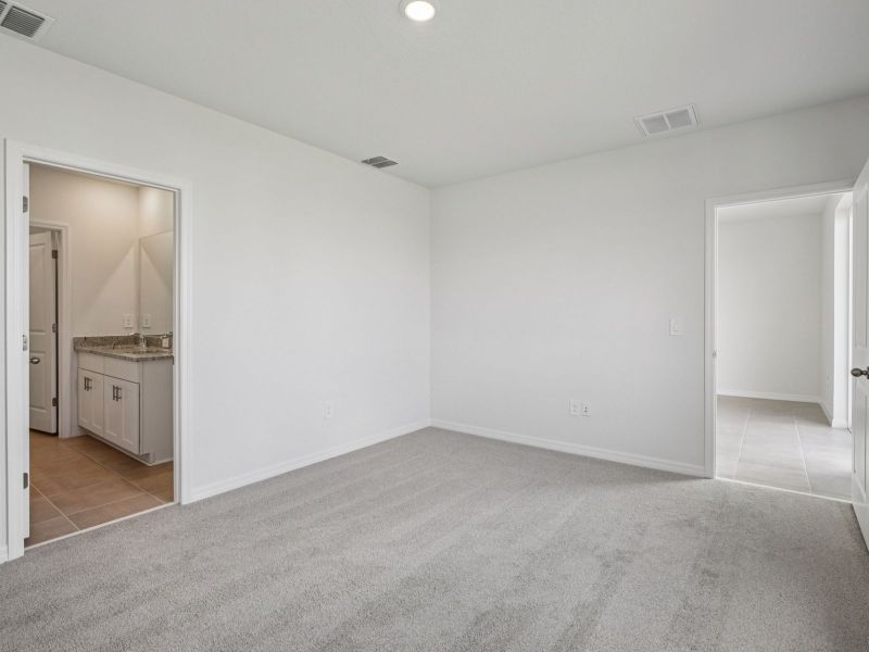 Spacious, unfurnished interior of a new home in The Grove at Stuart Crossing - Premier Series, Bartow (Image 12).