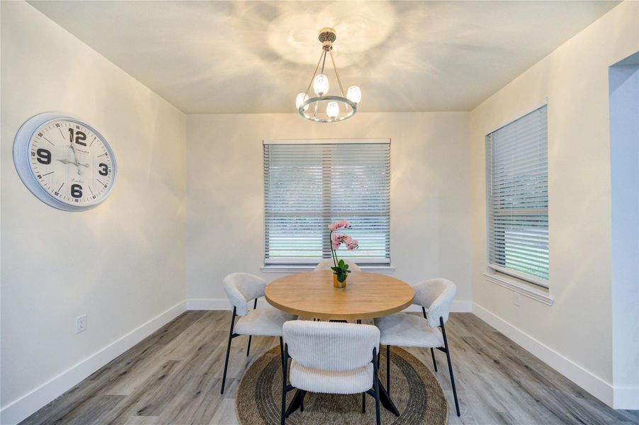 Bright and inviting dining area with modern lighting and ample natural light.