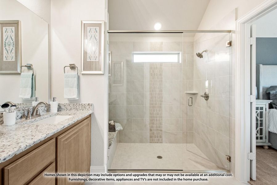 Ensuite bathroom with glass walk-in shower, tile walls, and granite vanity countertop with wood cabinets Ensuite bathroom with glass walk-in shower, tile walls, and granite vanity countertop with wood cabinets