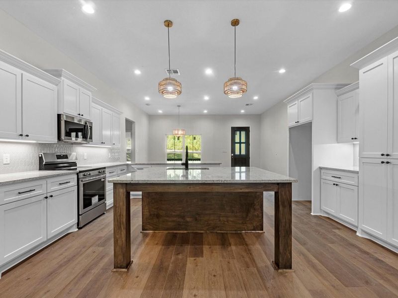 The interior is thoughtfully designed with elegant finishes throughout, a classy and durbale vinyl flooring, and ample storage in the kitchen and throughout the home
