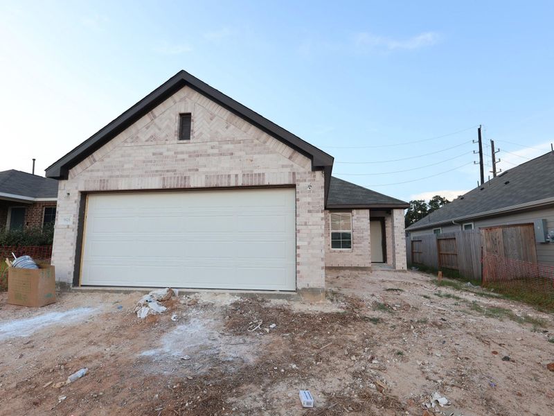 Front exterior of a new home in Magnolia Ridge, Magnolia, TX, highlighting curb appeal (Image 14). Front exterior of a new home in Magnolia Ridge, Magnolia, TX, highlighting curb appeal (Image 14).