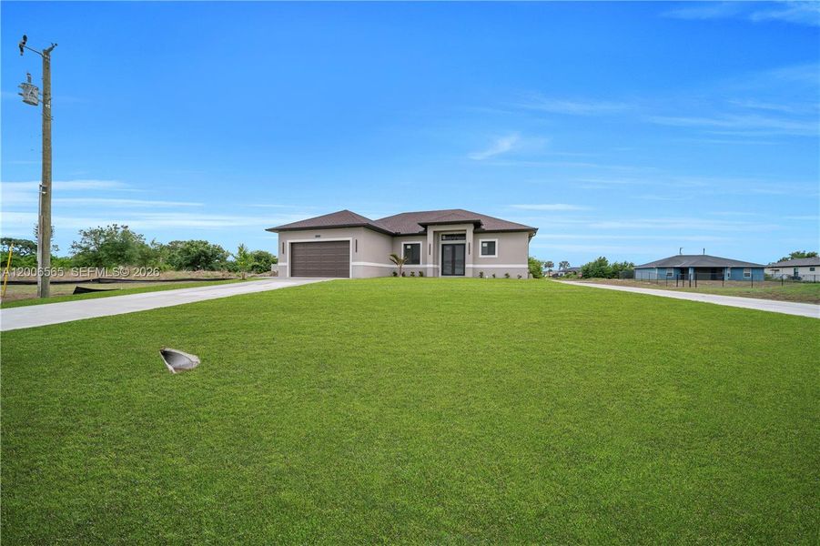 Front exterior of a new home in , Lehigh Acres, FL, highlighting curb appeal (Image 18).