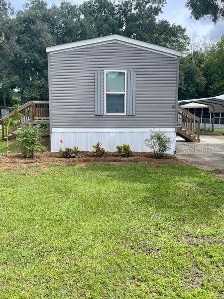 Front exterior of a new home in , Lake Wales, FL, highlighting curb appeal (Image 1).