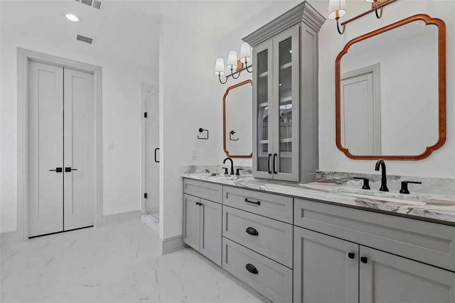 Bathroom featuring vanity and a shower with shower door