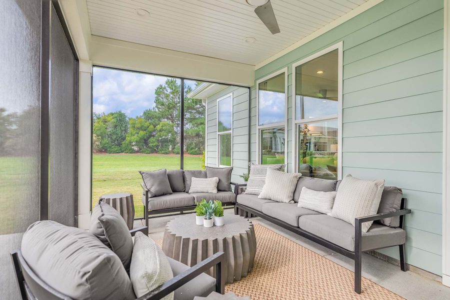 Screened porch with attached patio overlooking the backyard