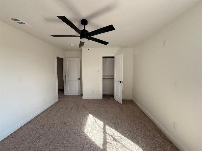 Unfurnished bedroom featuring a ceiling fan, carpet flooring, and a closet