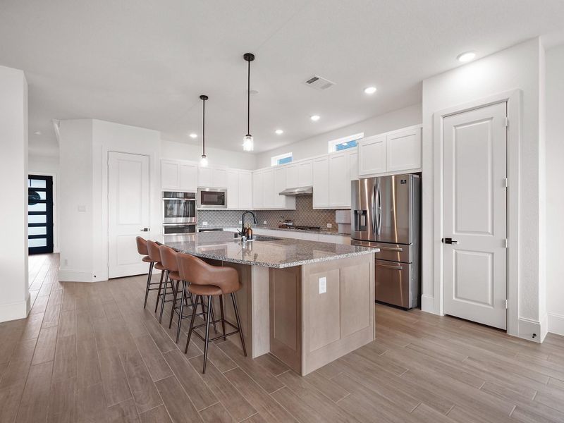 The heart of the home, this chef’s kitchen showcases granite countertops, a large central island, two pantries, and designer lighting. Whether you’re preparing family meals or hosting dinner parties, the open layout and high-end finishes make cooking and entertaining effortless.
