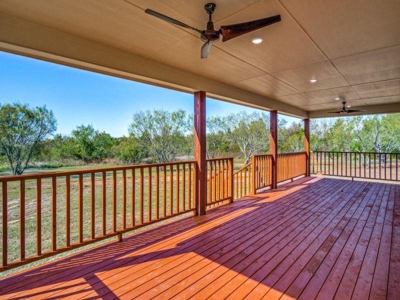 Wooden deck featuring ceiling fan