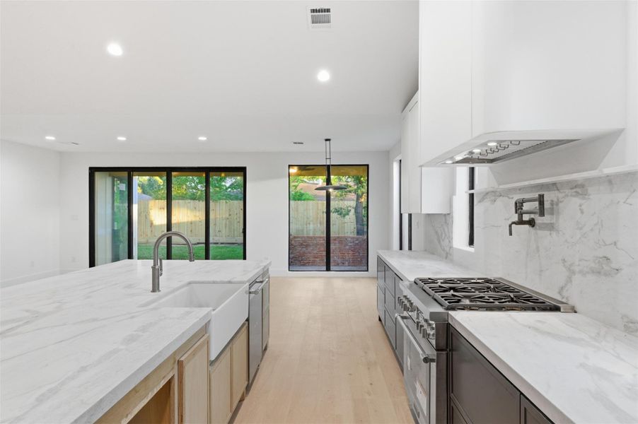 This modern kitchen is anchored by a huge statement island, offering the perfect setting for hosting family and friends.