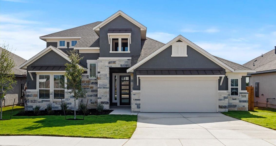 Front exterior of a new home in Village at Three Oaks, Seguin, TX, highlighting curb appeal (Image 1).