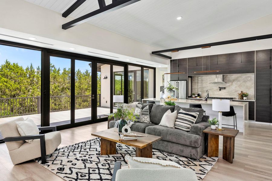 Living room with lofted ceiling, light wood-type flooring, and recessed lighting