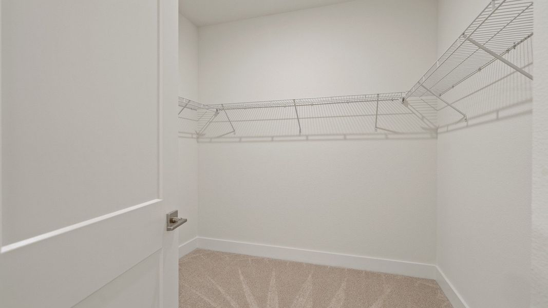 The Primary Suite Walk-in Closet of the Buttonwood by DRB Homes at Trailside in Mount Dora, FL.