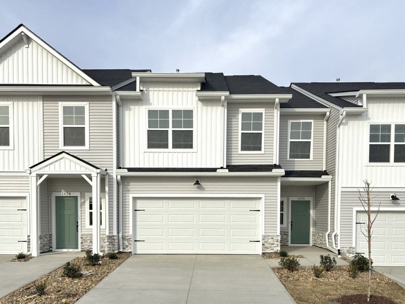 Front exterior of a new home in Reidville Town Center, Reidville, SC, highlighting curb appeal (Image 1). Front exterior of a new home in Reidville Town Center, Reidville, SC, highlighting curb appeal (Image 1).