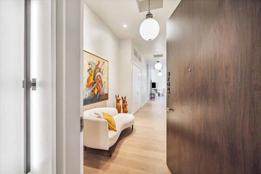 This luxury penthouse features 3 bedrooms, 3.5 baths, a large flex room, and expansive living, dining, bar, and pantry areas, with Pedini Italian cabinetry, porcelain countertops, premium appliances, and heated primary bathroom floors. Floor-to-ceiling windows, featuring Tailored motorized blackout shades, and 12-foot ceilings frame sweeping north and west views from a private balcony with plunge pool, complemented by a two-car garage with storage and an additional reserved parking space.