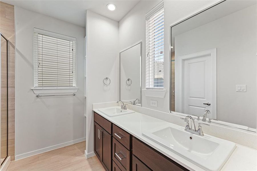 2nd Floor - Primary Bathroom with dual vanity sink and standing shower.