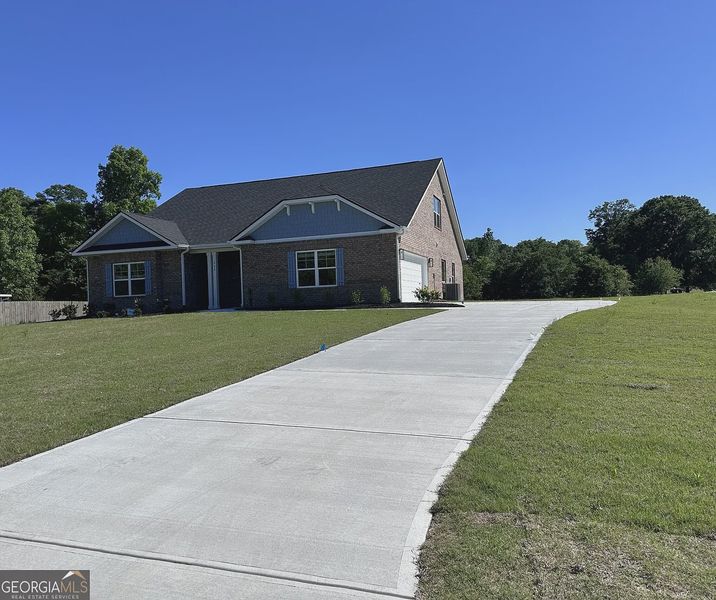 Front exterior of a new home in Oakview Estates, Macon, GA, highlighting curb appeal (Image 1). Front exterior of a new home in Oakview Estates, Macon, GA, highlighting curb appeal (Image 1).