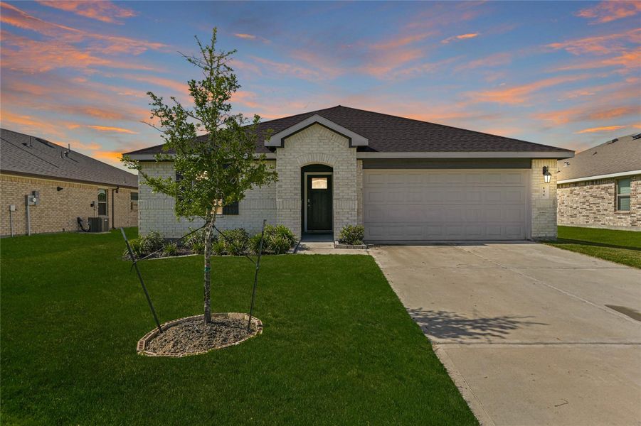 Charming one-story brick home with manicured lawn, covered front porch, and inviting curb appeal in a peaceful community