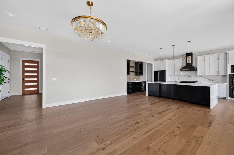 Gleaming hardwood floors and a modern open floorplan connect the main living areas seamlessly.