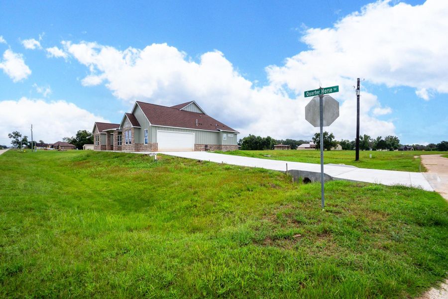 Charming single-story home on a spacious corner lot with a well-maintained lawn and a wide driveway leading to a two-car garage. Charming single-story home on a spacious corner lot with a well-maintained lawn and a wide driveway leading to a two-car garage.
