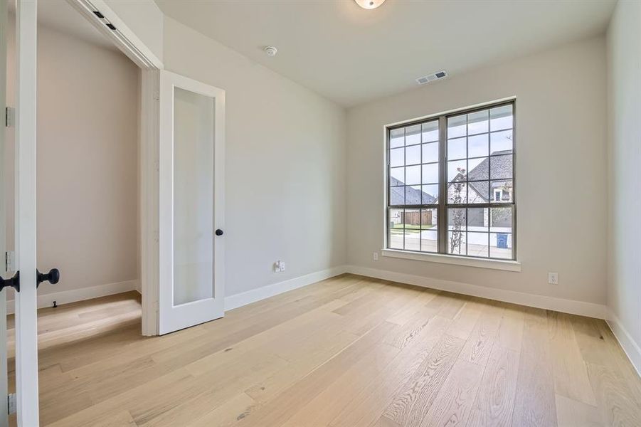 Unfurnished room with light wood-type flooring and baseboards Unfurnished room with light wood-type flooring and baseboards