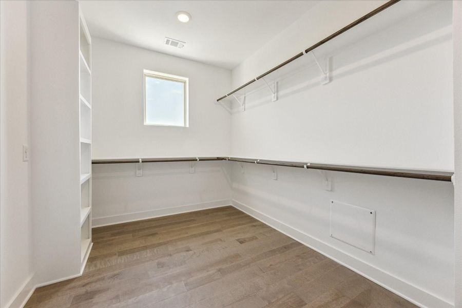 Primary Bedroom has a Walk In Closet with Shelving and Window. Primary Bedroom has a Walk In Closet with Shelving and Window.