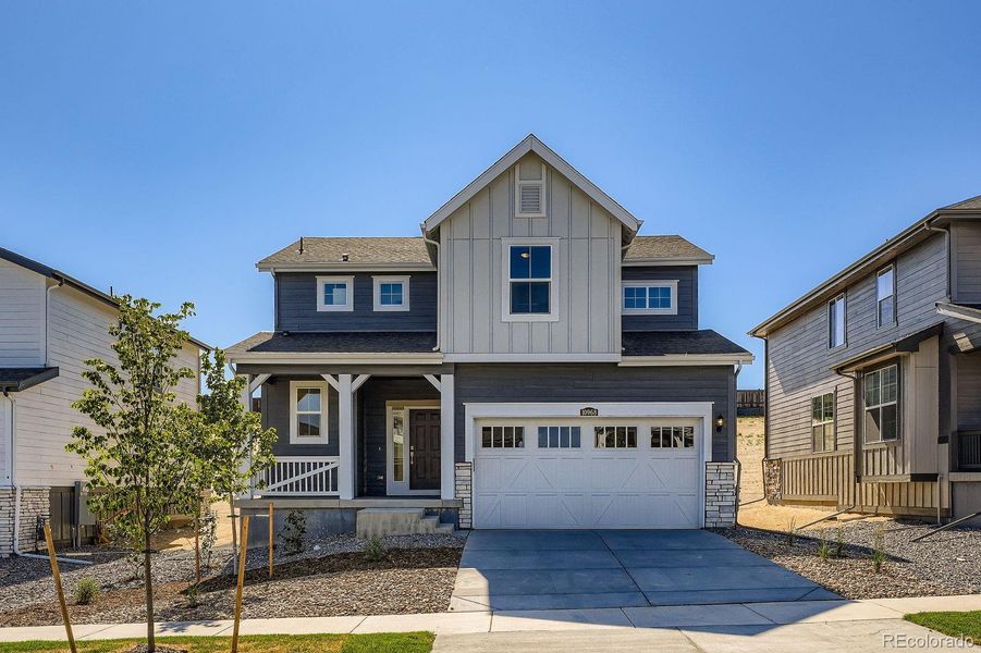 Front exterior of a home in the Newlin Crossing: The Pioneer Collection community, located in Parker, CO (Image 9).