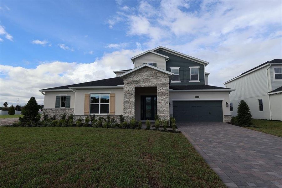 Front exterior of a new home in Solace at Corner Lake, Orlando, FL, highlighting curb appeal (Image 29).