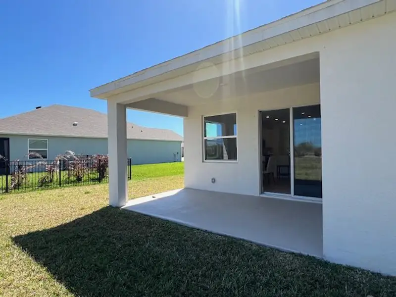 Exterior details and patio area of a home in Lakes At St Sebastian, Micco (Image 4).