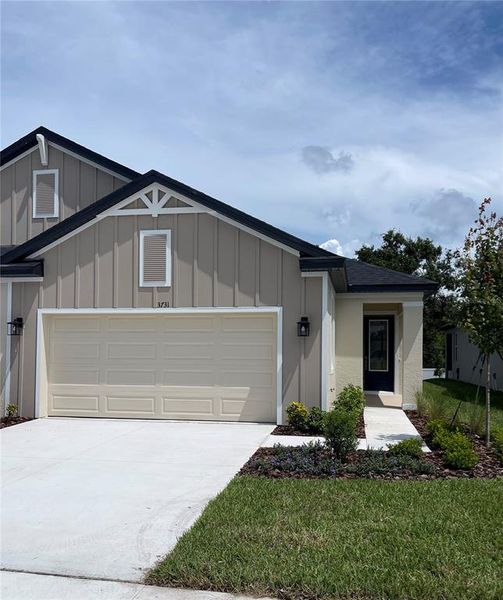 Front exterior of a new home in Fairway Pointe - 55+ Villa Community, Sun City Center, FL, highlighting curb appeal (Image 1).
