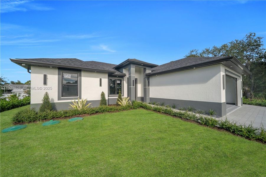 Front exterior of a new home in , Lehigh Acres, FL, highlighting curb appeal (Image 24).