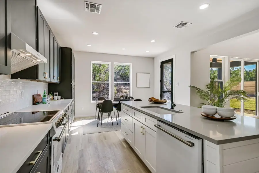 Kitchen featuring stainless steel electric range, dishwasher, recessed lighting, light wood-style flooring, and under cabinet range hood